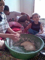 "This is me making bread, with my daughter and my sister’s son. I can’t afford to buy bread, so I am always making it at home and it takes a long time. It’s also exhausting because I work full-time. I have to find time to work, clean my house, make bread, take care of my daughter…"